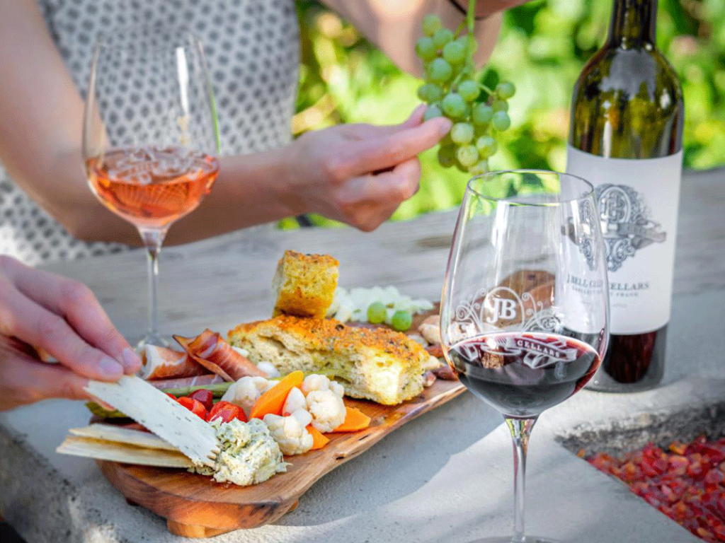 Couple enjoying some light bites with wine at J Bell Cellars and Il Grasso in Zillah, WA